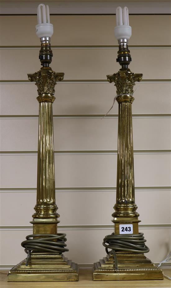 A pair of brass corinthian column table lamps and shades, 56cm